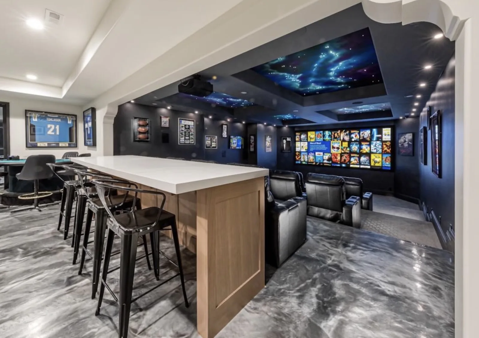 Open-concept theater with tiered seating, star ceiling, bar and game room
